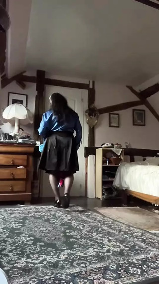 In a black skirt outfit with a royal blue lavaliere blouse and tie