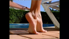 Wonderful MILF with Nice Tits Massages Her Feet by the Pool While Sunbathing
