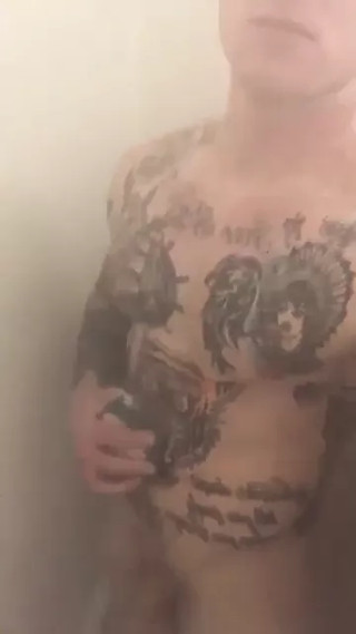 Tattooed muscle soldier in the shower