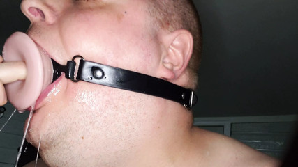 Deepthroating a 7 inch dildo with mouth gag ring