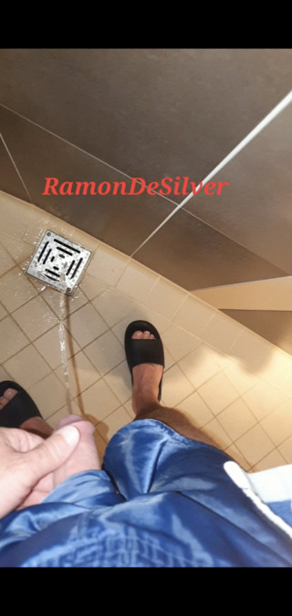 Master Ramon pisses next to the urinal in sexy blue satin shorts, lick it on slave