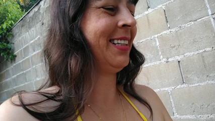 Amateur wife teasing you outside wearing a micro bikini