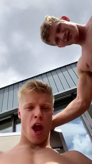 Four naked boys pose in front of the house