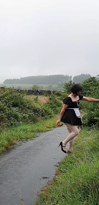 Crossdressing slut Maid on a public lane in the rain
