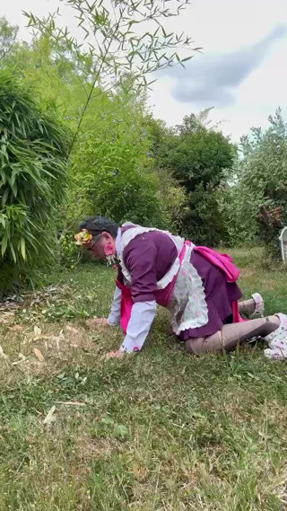 In gardener's outfit, peeing on all fours like a dog