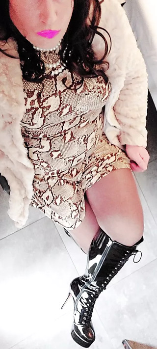 Crossdresser in fur and high heel boots