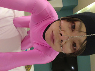 A cross-dressing boy has been transformed into a cute pink female pig with full-body tights and a nose hook. thumbnail