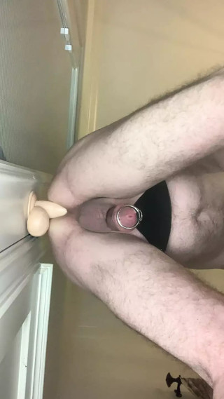 Caged Cock on a Dildo thumbnail