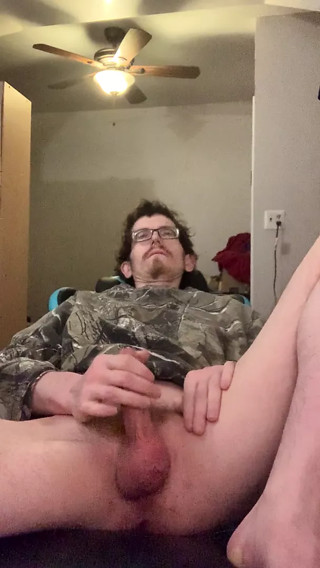 Denzel James masturbates in his chair in a camo sweater