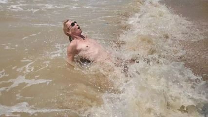 Swimming, splashing and posing naked in the sea...