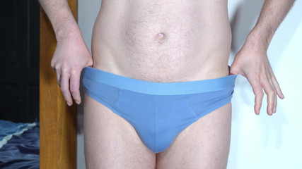 Zoom in close up as man takes off underwear and wanks his uncut cock from soft to throbbing erection