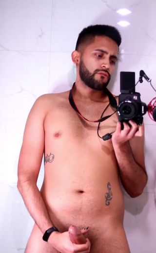 Horny latino stroking his big uncut dick in the mirror until he cums