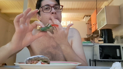 Pig guy eats a sandwich while jerking big cock
