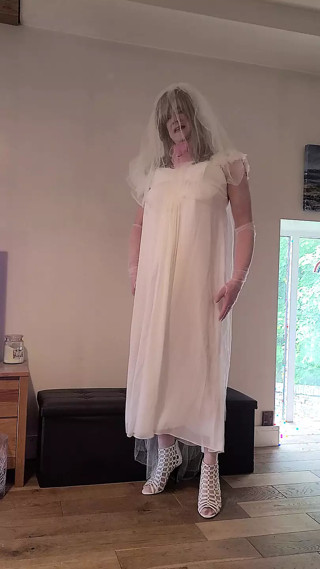 Sissy wearing a wedding dress caged and plugged thumbnail