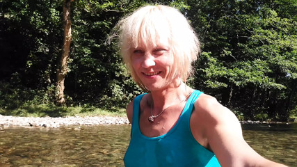 Sexy t-girl swimming in mountain river and wetting teal summer dress ... thumbnail