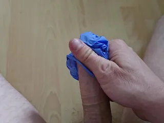 Pampered my cock with a latex glove.