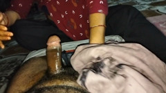 A desi wife massaging her husband's member with oil using her soft hands at night.