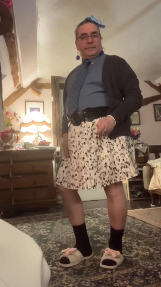 Dressed with a shirt and tie and a skirt with feminine underwear for a night out