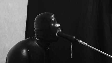 Rubber gimp train is throat with fuck machine