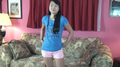 Asian broad with tattoos poses nude on the couch