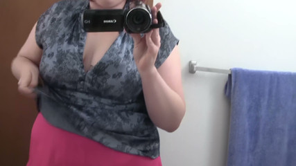 Busty Redhead in Glasses Films Herself Naked in the Bathroom Mirror