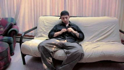 He strokes his cock on the couch