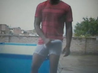 guy on roof outside rubbing huge bulge