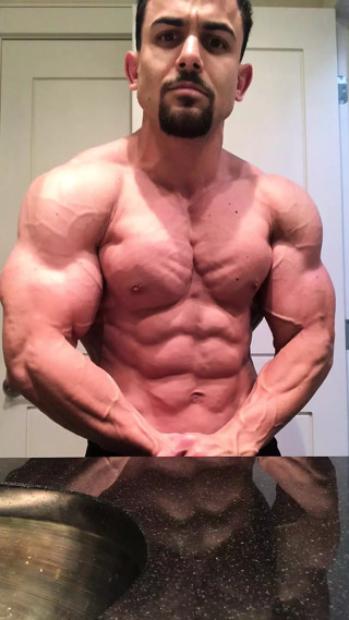 Jacked bodybuilder Benji Bastian flexing his huge, shredded, muscles