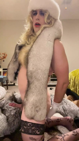 Fur slut tries on fur coats