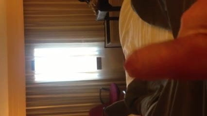 Stroking uncut cock by hotel window