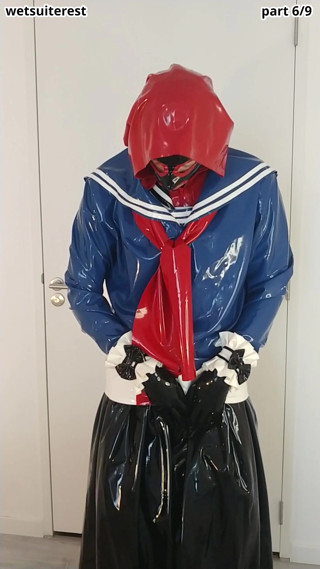 Putting on another latex Japanese schoolgirl sailor uniform and cuffs over rubber dress, layers thumbnail