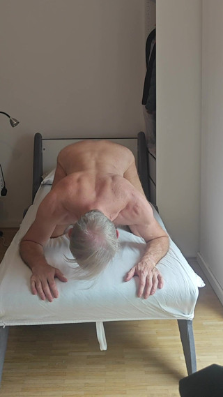 Naked stretched in a bed