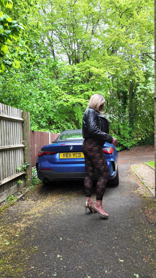 Crossdresser kellycd2022 in black leather jacket and lace catsuit and heels thumbnail
