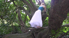 She climbs on tree and fingers her pussy