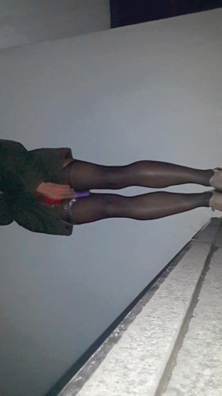 A college bitch in open bottom stockings with a vib controller taped to her thigh walks through school and flashlights herself. thumbnail
