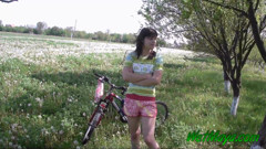 Peeing on her bicycle