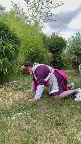 In gardener's outfit, peeing on all fours like a dog