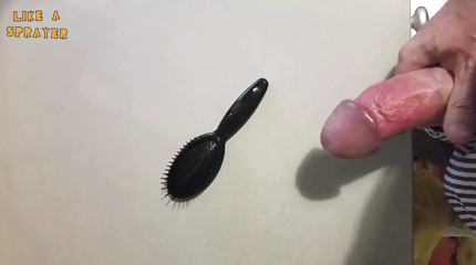 Jerking off on a small hairbrush, cumshot with a lot of cum from a big cock by an handjob.