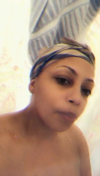 Horny African mature bathing