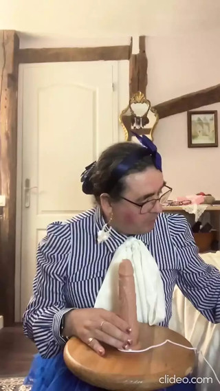 In an outfit with a blue petticoat to suck a dildo