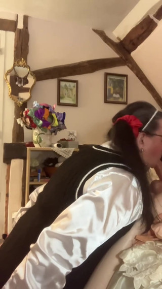 In an outfit with a schoolgirl-style wool dress to suck Marcel the inflatable doll with his hands tied behind his back thumbnail