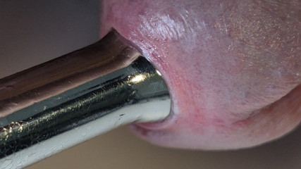 Pulling out extremely tight 14mm urethral teardrop plug close-up.
