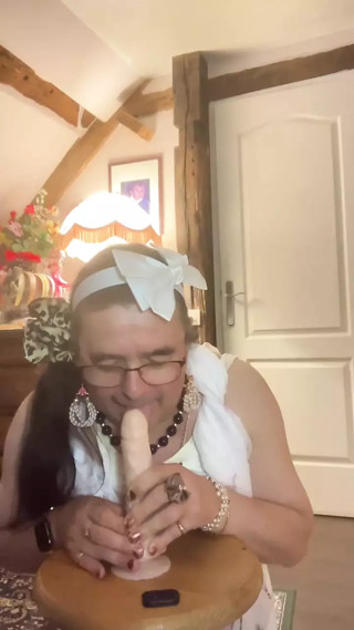 In outfit with a white ball dress for an evening to suck a dildo