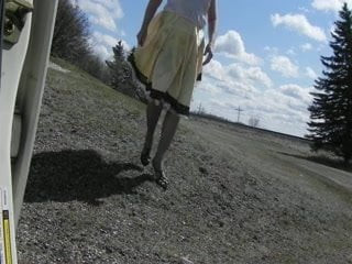 Sissy Ray outdoors on windy day gold dress