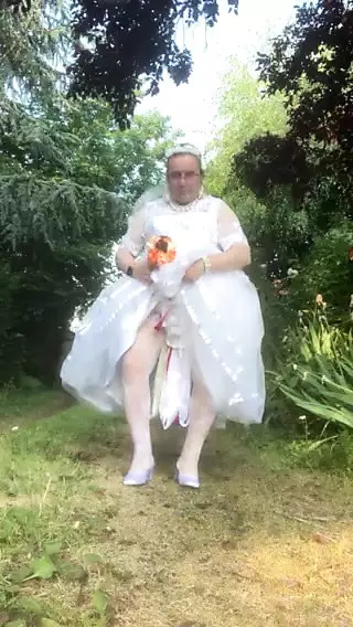 Second white wedding dress in satin and tulle on a walk thumbnail