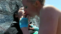 Tattooed Blonde and Her Girlfriend Lick Each Other Outdoors on the Rocks
