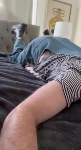 Fully clothed humpies on bed with pillow thumbnail