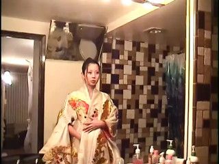 Man shoves cock in asian's mouth while she lays in bed
