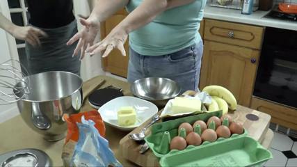 Petite girl bakes with chubby granny