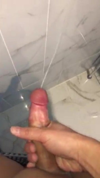 Asian guy large cum load on the bathroom wall